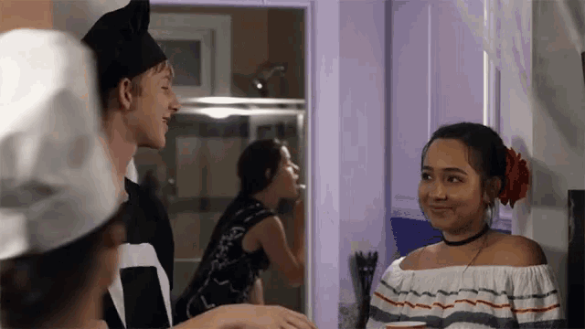 a man in a chef hat talks to a woman