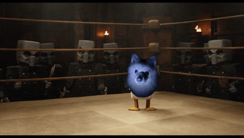 a blue dog is standing in a boxing ring with soldiers