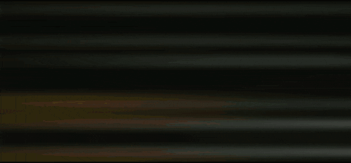 a yellow light is shining behind a gray curtain