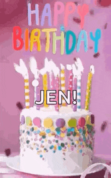 a birthday cake with candles and sprinkles is on a plate on a table .