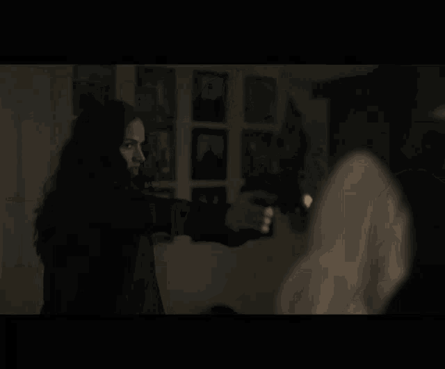 a man with long hair and a beard talks to a woman