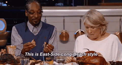 a man and a woman are sitting at a table eating food and the man says this is east-side-long-beach style