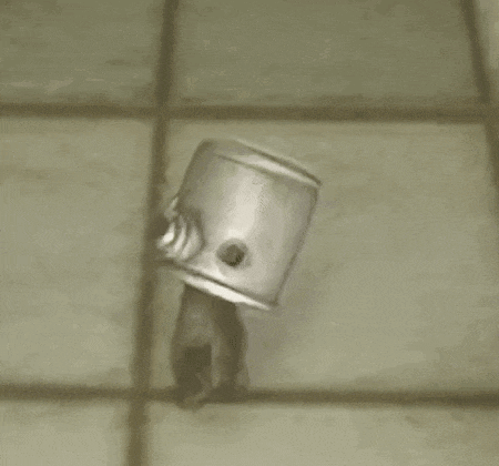 a can with a person 's head sticking out of it is on a tiled floor .