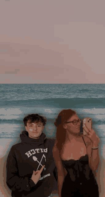 a man and a woman are posing for a picture with the man wearing a hoodie that says hotiu