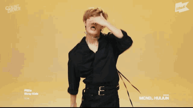 a young man wearing a choker and a black shirt with the words count dance on the bottom right