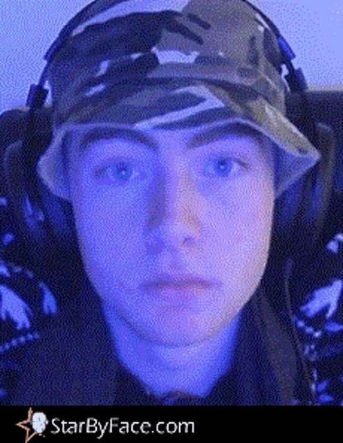 a young man wearing a hat and headphones is taken from starbyface.com
