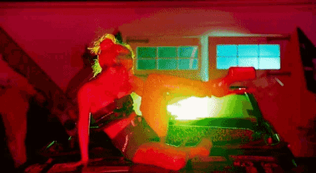 a woman is laying on her stomach on a bed in a room with a lot of lights .
