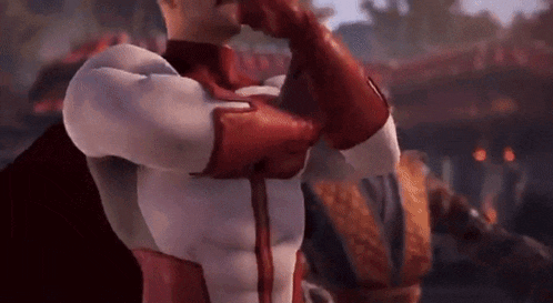a man in a red and white superhero suit is saluting .