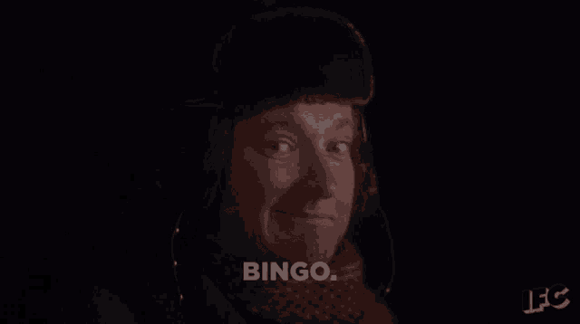 a man wearing a fur hat and scarf is saying bingo