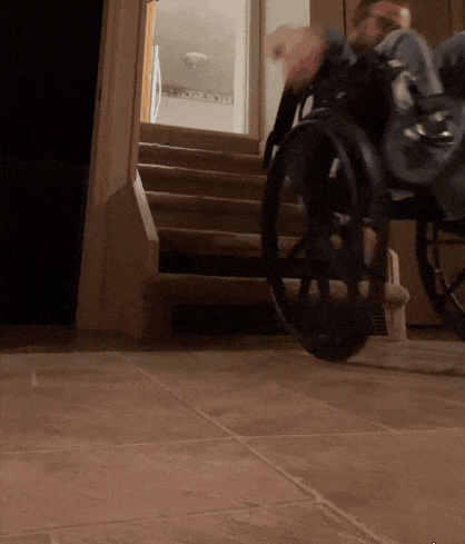 a person in a wheelchair going up stairs