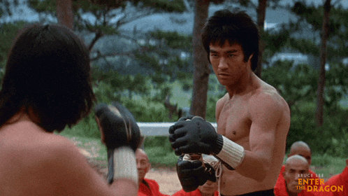 a bruce lee enter the dragon poster shows two men boxing