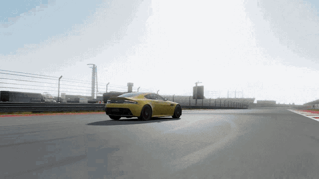 a yellow car is driving down a race track