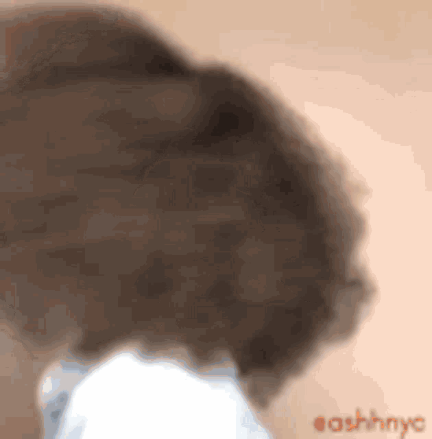a close up of a person 's hair with ashhnyc written in red .