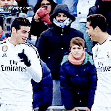 two soccer players with fly emirates on their jerseys