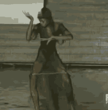 a woman in a very short dress is standing on a rock .