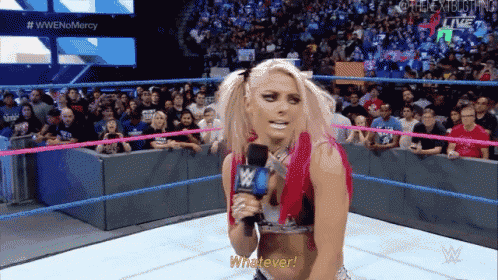 a woman in a wrestling ring is holding a microphone and saying " whatever "