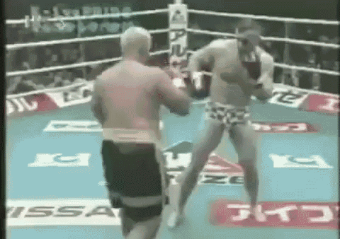 two men are fighting in a boxing ring with a sign that says issa on it .