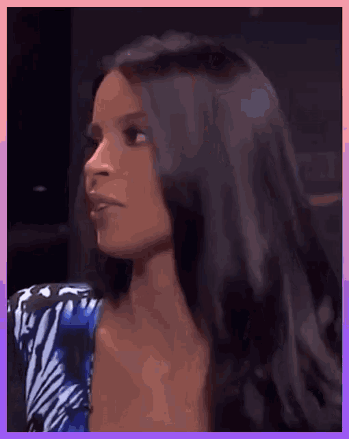 a woman with long dark hair is wearing a zebra print dress