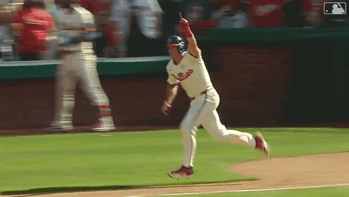 a baseball player with the word phillies on his jersey is running on the field