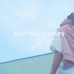 a person standing in front of a blue wall with the words " your life is yours fire "