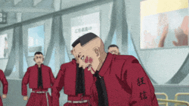 a man wearing a red jacket with chinese writing on the sleeve