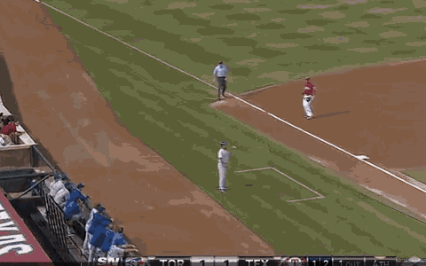 a baseball player wearing a number 2 jersey stands on the field