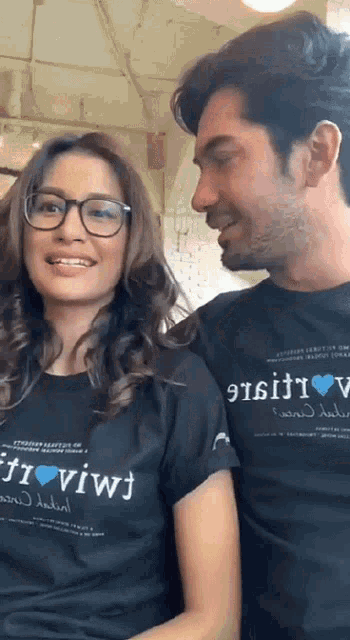 a man and a woman wearing black shirts that say " i love vivi "
