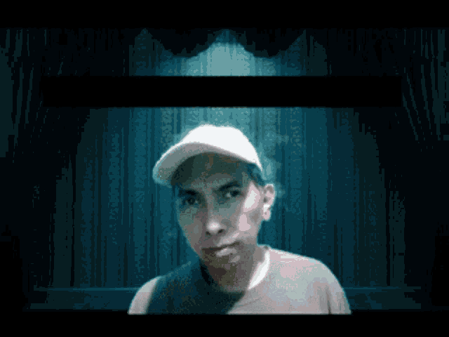 a man in a baseball cap is standing in front of a stage
