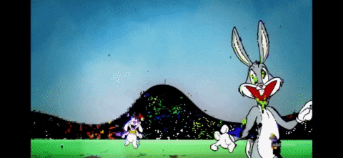 bugs bunny is standing in a field with two rabbits behind him