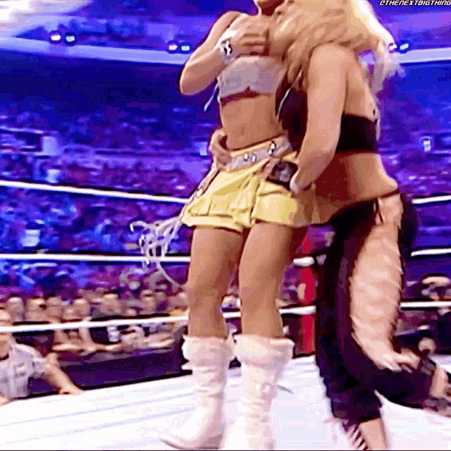 two women wrestling in a ring with the hashtag #thenextbigthing