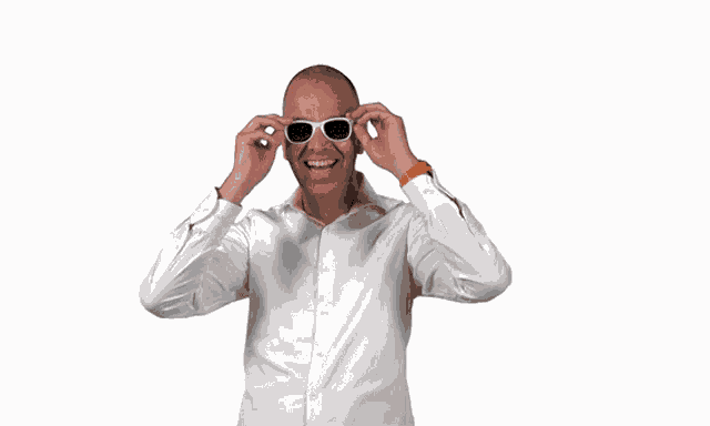 a man wearing sunglasses and a watch is giving a thumbs up