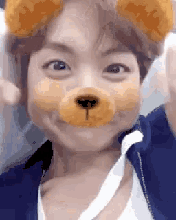 a person with a teddy bear mask on their face .