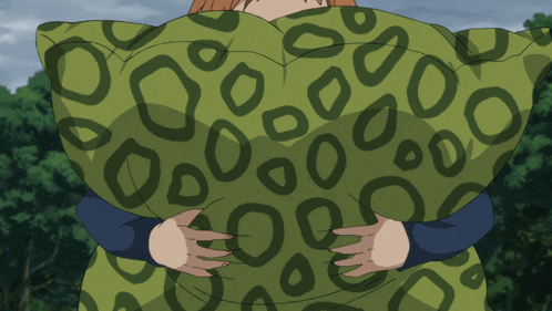 a person is holding a green pillow with a leopard print
