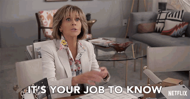 a woman sitting at a desk with the words " it 's your job to know "