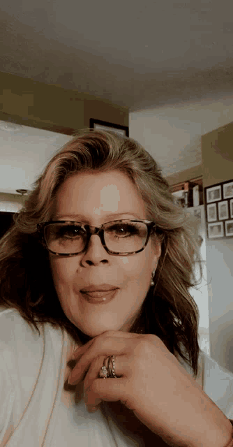 a woman wearing glasses and a diamond ring