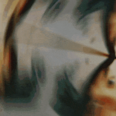 a blurred image of a person holding an umbrella with a gray background