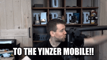 a man is standing in front of a microphone and says to the yinzer mobile !