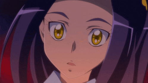 a close up of a girl 's face with yellow eyes and purple hair