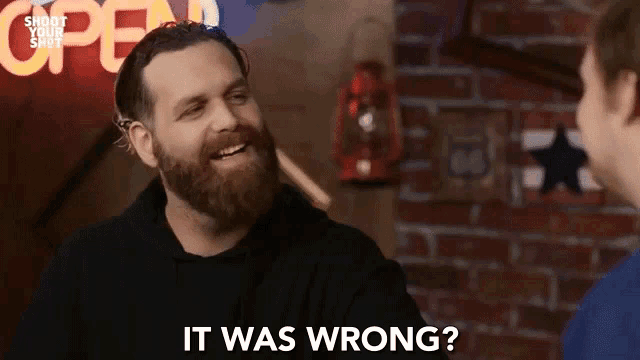a man with a beard is talking to another man and says it was wrong .