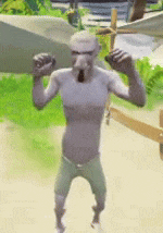 a man without a shirt is standing on a beach holding a sword .