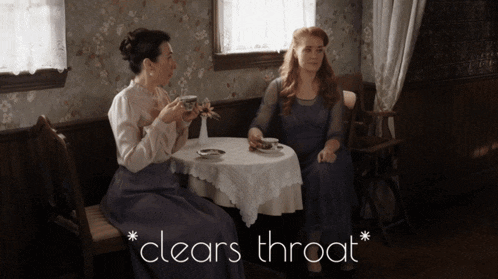 two women sit at a table with the words clears throat