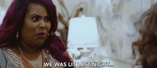 a woman with purple hair says " we was lit last night " in front of a lamp