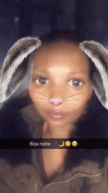 a woman with bunny ears on her face has boa noite written on the bottom