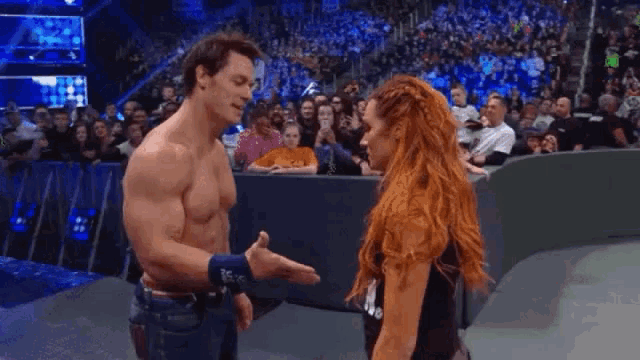 a man and a woman are standing next to each other on a stage .