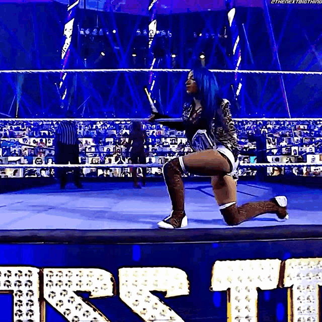 a woman in a wrestling ring with the word first in the background