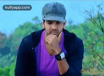 a man wearing a purple shirt and a hat is thinking .