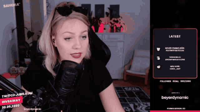 a woman sitting in front of a microphone with the words twitch jubileum giveaway on the bottom