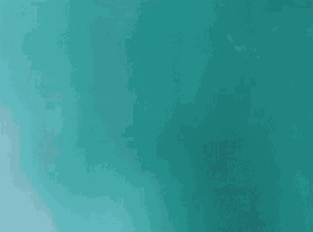 a close up of a person 's fist on a blue background .
