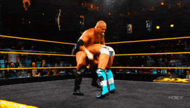 a wrestler is being pinned down by another wrestler in a nxt ring