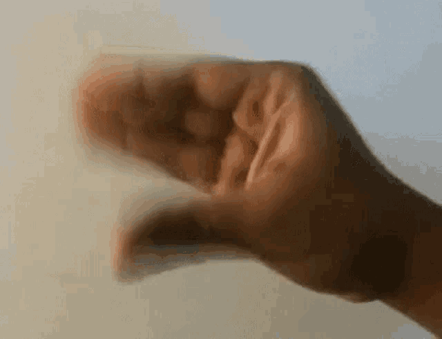 a close up of a person 's hand making a fist .
